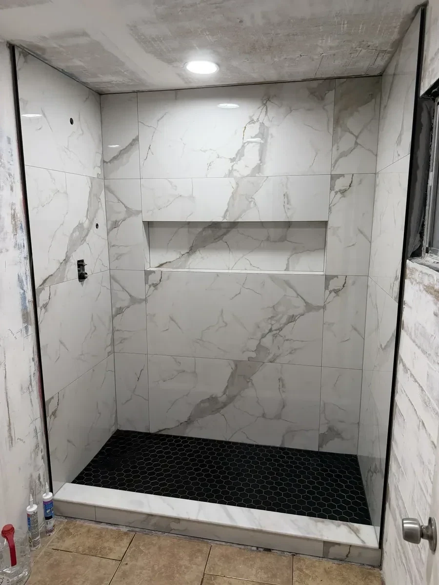 Calacatta Porcelain Shower Calacatta Porcelain Shower with Black Hex Mosaic Floor Phoenix AZ | Albaner Tile and Stone