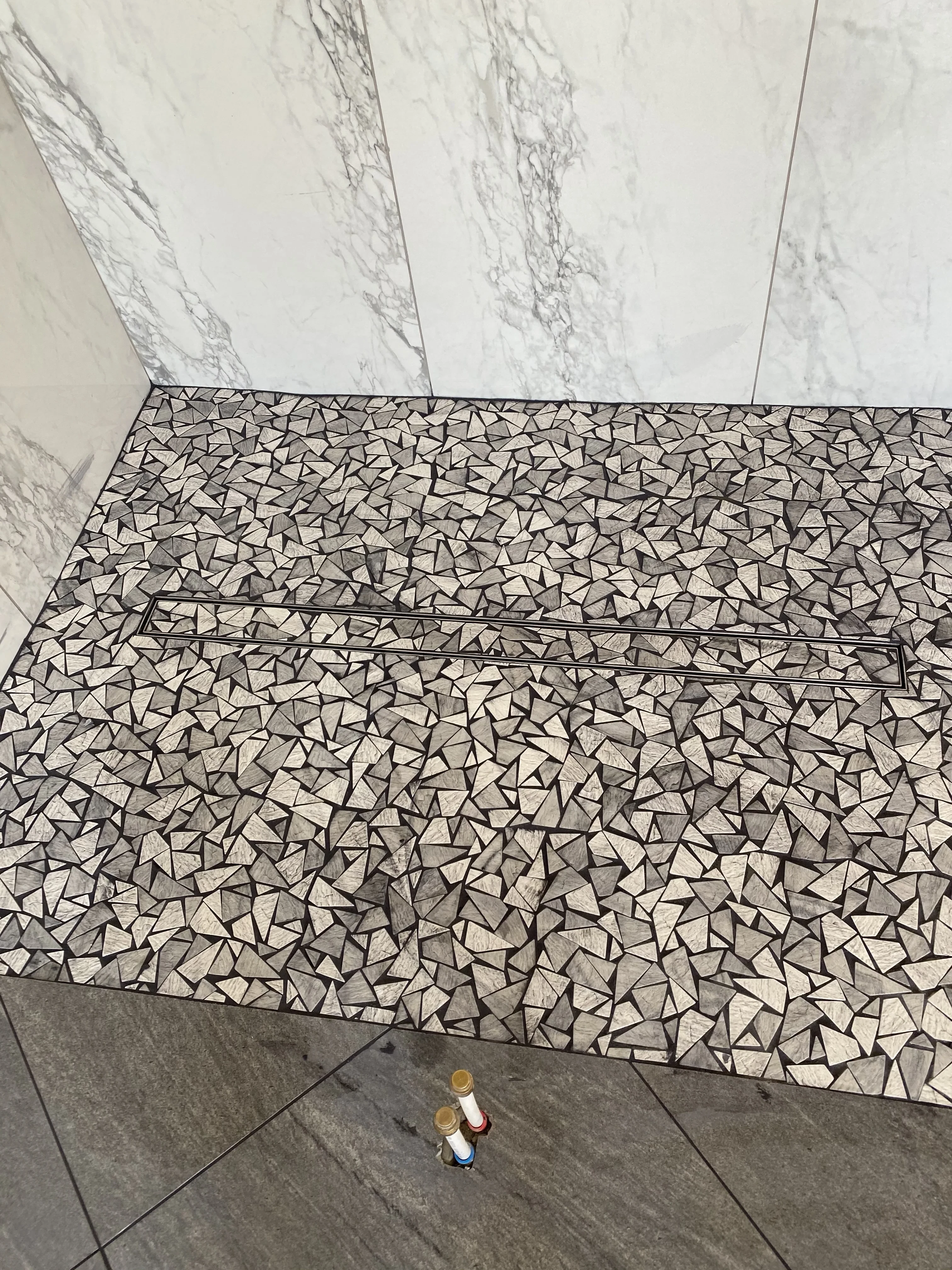 Pebble Mosaic Shower Floor with Marble Walls