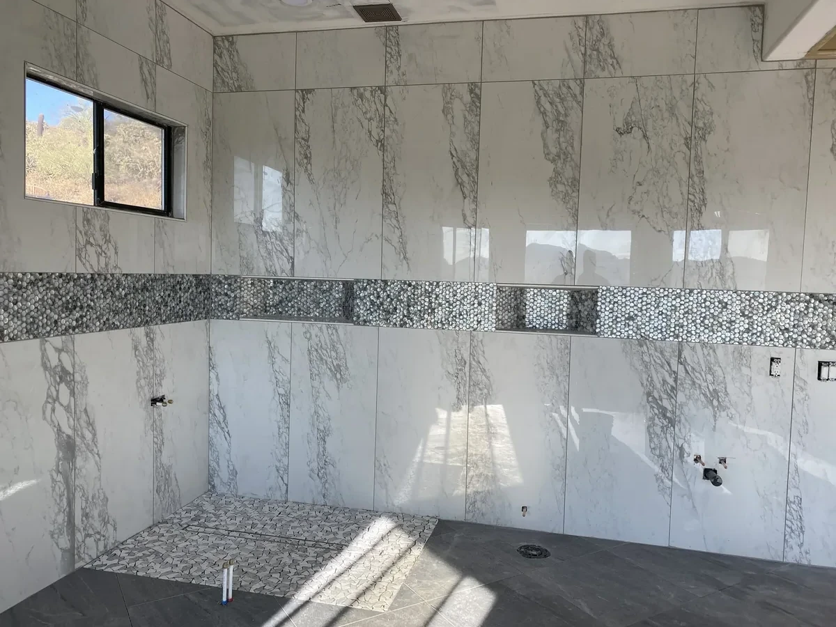 Large Format Marble Shower Large Format Calacatta Marble Shower with Penny Tile Niche | Albaner Tile and Stone Phoenix