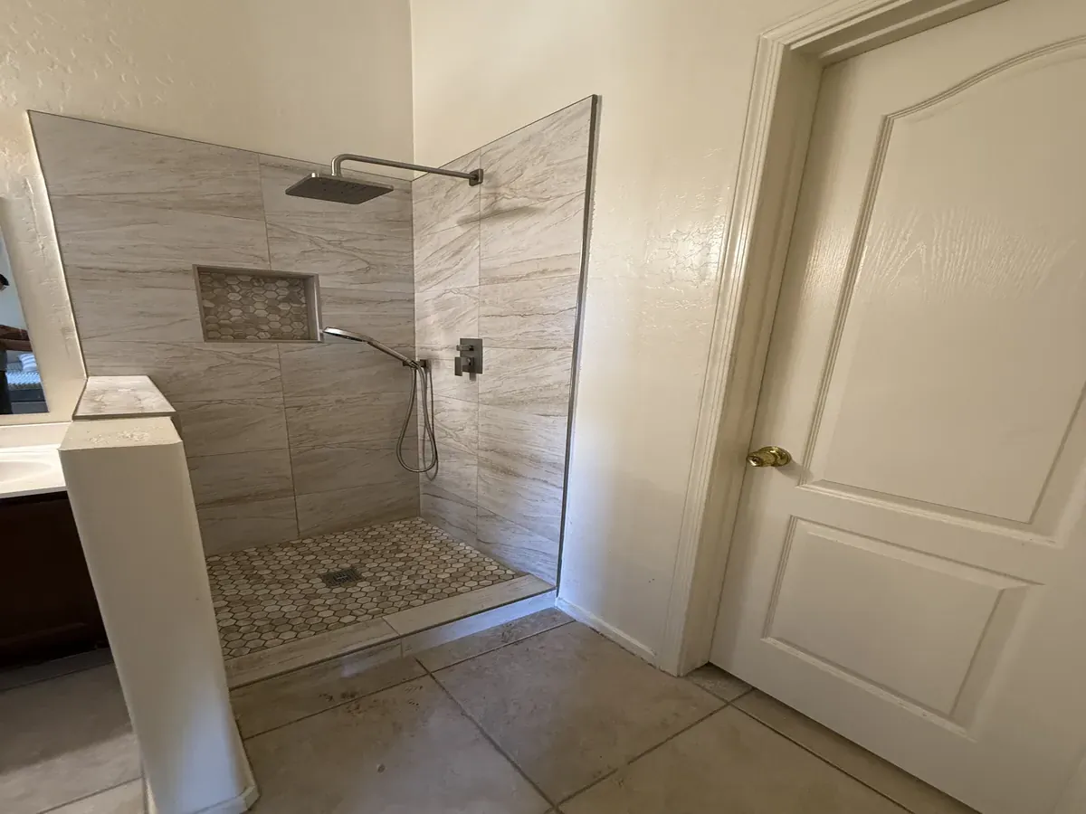 Travertine Porcelain Walk-In Travertine-Look Porcelain Walk-In Shower with Hex Mosaic Niche Phoenix AZ | Albaner Tile and Stone