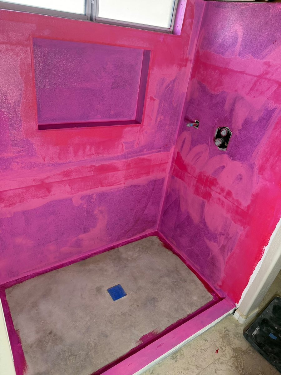 Tile shower fully waterproofed with RedGard liquid membrane before tile installation, including a recessed niche, shower window, valve and curb, Phoenix | Albaner Tile and Stone